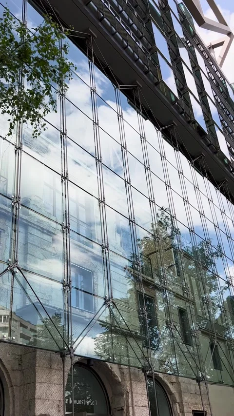 Contemporary reflection of modern architecture on the facade of a glass building Stock Footage 303891958