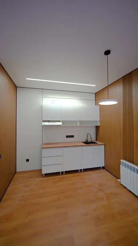 Contemporary White Kitchen Interior with Wood Accent Walls Stock Footage 345981261