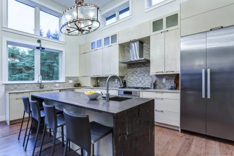 Contemporary white kitchen with Upscale kitchen appliances, custom built cabi Stock Photos