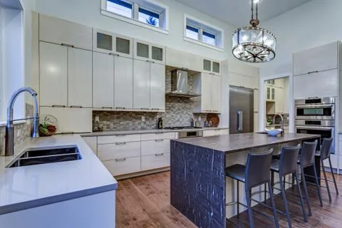 Contemporary white kitchen with Upscale kitchen appliances, custom built cabi Stock Photos