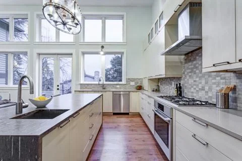 Contemporary white kitchen with Upscale kitchen appliances, custom built cabi Stock Photos