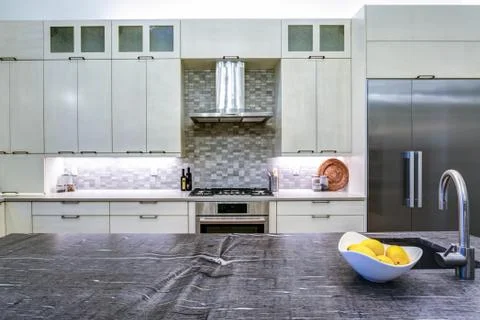 Contemporary white kitchen with Upscale kitchen appliances, custom built cabi Stock Photos
