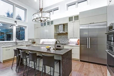 Contemporary white kitchen with Upscale kitchen appliances, custom built cabi Stock Photos