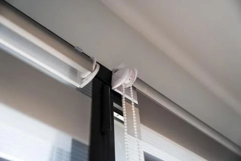 Contemporary window installation with zebra roller blinds showing roller system Foto stock