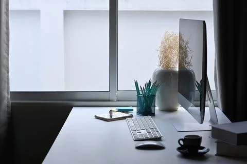 Contemporary workplace with computer pc, stationery and coffee cup on white Stock Photos