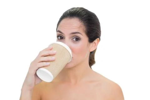 Content bare brunette drinking from disposable cup Stock Photos
