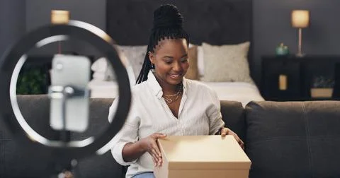 Content creator, box and black woman in home for recording, unboxing and pr.. Stock Photos