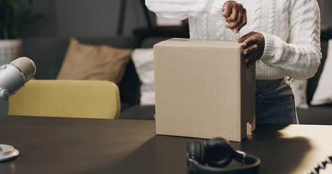Content creator, box and hands of person in home for recording, unboxing an.. Stock Photos