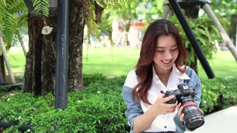 Content Creator Checking Images on Camera After Photo Shoot Stock Footage 341661142