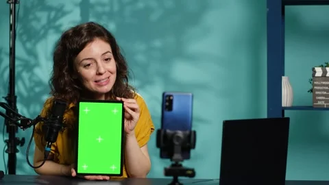 Content creator filming tech tutorial on how to repair damaged chroma key tablet Stock Footage 318456579