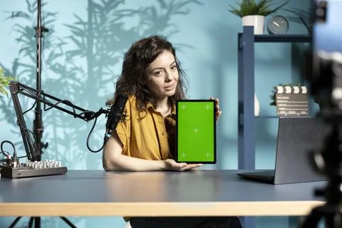 Content creator filming tech tutorial on how to repair damaged chroma key tablet Stock Photos