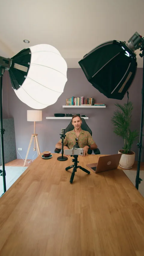 A content creator is filming a video in their home studio using professional Stock Footage 276342023