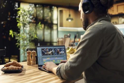 Content creator, headset editing, video footage on laptop, videography Foto stock