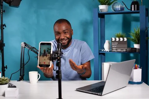 Content creator interacting with fans looking at live video podcast setup moving Stock Photos