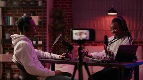 Content creator interviewing famous vlogger recording vlog using digital camera Stock Footage 190395781