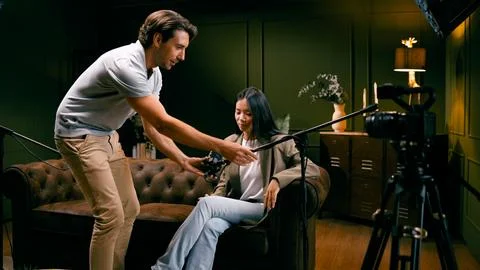 Content creator preparing guest for podcast recording Stock Photos