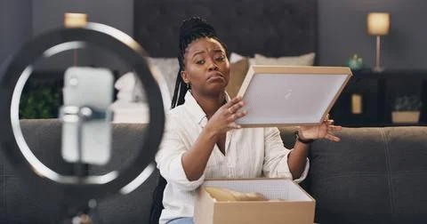 Content creator, ring light and black woman with box in home for recording,.. Stock Photos