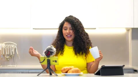 Content creator streaming online while having breakfast at home Stock Footage 277790807