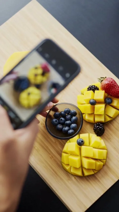 Content Creator Taking Smartphone Photo of Fresh Mango and Berries Stock Footage 344016131
