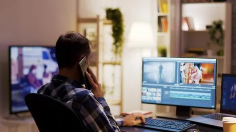 Content creator talking on the phone while working on a multimedia project Stock Photos