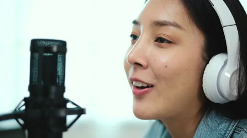 Content creator woman host streaming his a podcast on laptop with headphones. Stock Footage 194612863