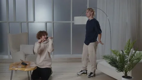 Content creators recording dance video for their vlog. Twins brothers waving Stock Footage 232470566