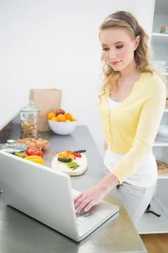 Content cute blonde using laptop Stock Photos