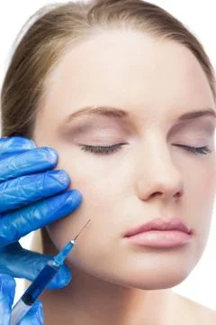 Content cute model having botox injection on the cheek Stock Photos