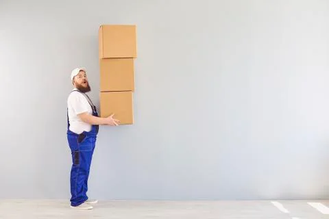 Content delivery man with pile of boxes Stock Photos
