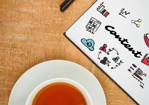 Content doodle on notepad next to tea Stock Photos