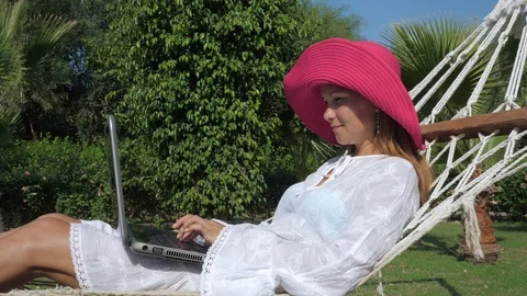 Content female freelancer using laptop on vacation Video stock 124630292