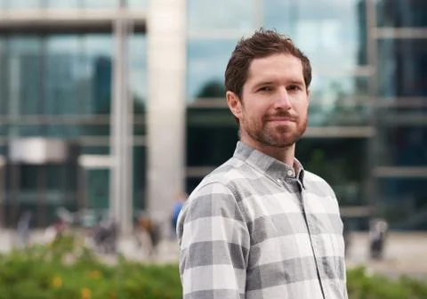 Content handsome man standing alone on a city street Foto stock