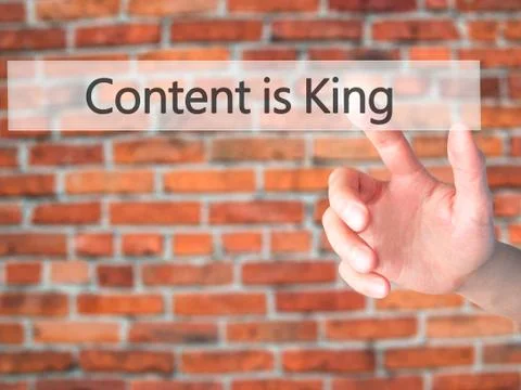 Content is King - Hand pressing a button on blurred background concept on vis Stock Photos