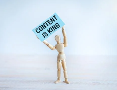 Content is King Text on Paper in the Hands of a Wooden Man. Stock Photos