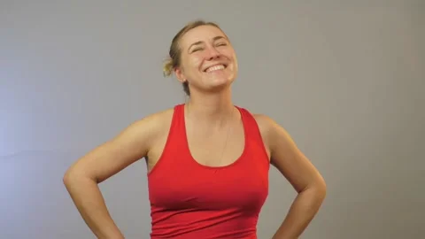 Content lady in red top nods and smiles sincerely in studio Stock Footage 135131441