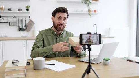 Content maker filming unpacking process of parcel box Stock Footage 253333166