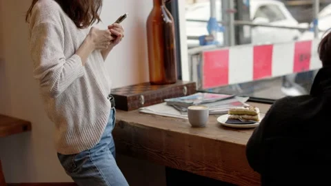 Content maker working on story telling with creative shots on cellphone in cafe Stock Footage 218236703