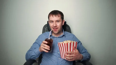 Content man with popcorn watching funny movie Stock Footage 103496846