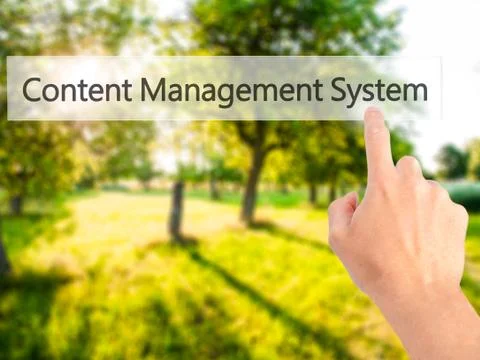Content Management System - Hand pressing a button on blurred background conc 스톡 사진