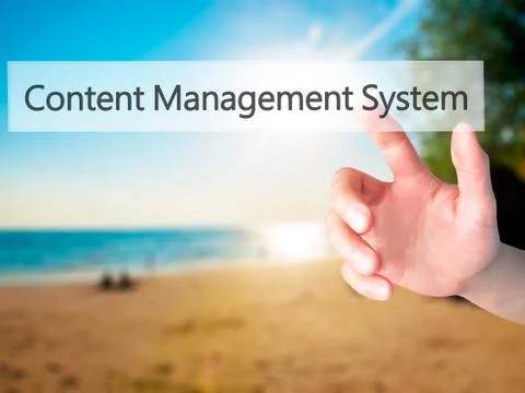 Content Management System - Hand pressing a button on blurred background conc Foto stock