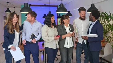 Content multiethnic colleagues chatting in office Stock Footage 269346708