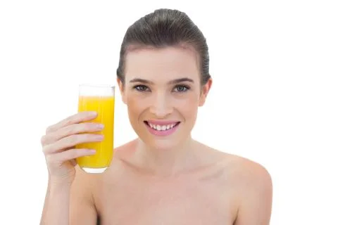 Content natural brown haired model holding a glass of orange juice Stock Photos