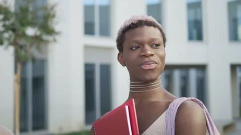Content queer black man with folder on street Stock Photos