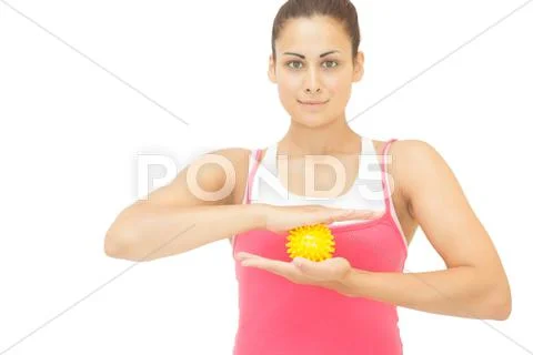 Content sporty brunette holding yellow message ball Stock Photos