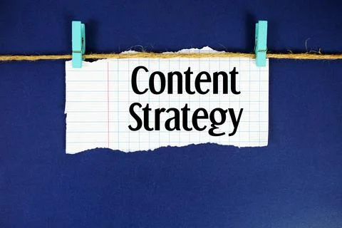 Content Strategy text written on rip paper with wooden clip on blue backgroun Stock Photos