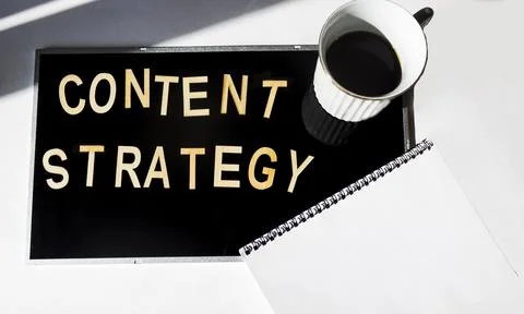 Content strategy word cloud on black background with notepad and coffee cup. Stock Photos