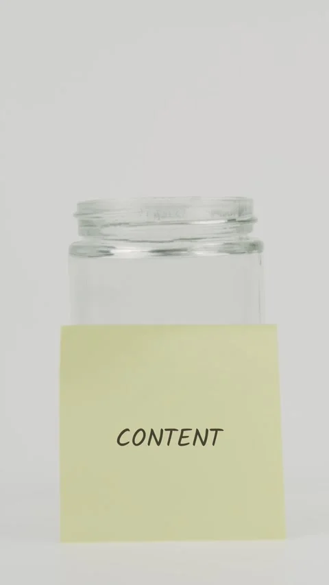 Content text or word on yellow sticky note attached to glass jar with hand Stock Footage 311697704