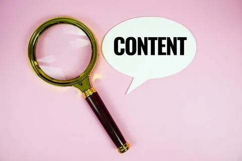 Content text on speech bluble with magnifying glass top view on pink backgrou Stock Photos