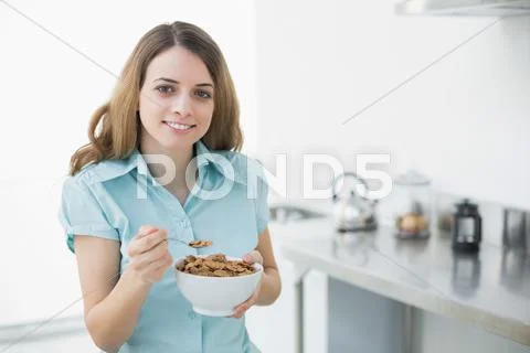 Content woman showing a bowl filled with cereals Stock Photos