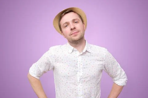 Content young man in summer hat standing isolated over colored background Stock Photos